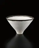 Large conical "Rice" bowl by Lucie Rie, circa 1978, Porcelain, matte white glaze with golden lip, the glaze flowing into pierced dots in the body, sold Dec 2013