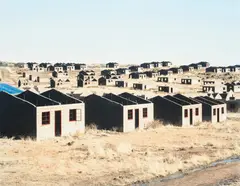 David Goldblatt, Incomplete houses, part of a stalled municipal development of 1,000 houses, Lady Grey, Eastern Cape, 2006, archival pigment print, mounted
