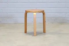 'Model 60' stool by Alvar Aalto, 1933, the circular birch seat raised on birch bentwood supports, sold Jul 2024