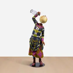 Water Kid (Girl) by Yinka Shonibare Cbe Ra, 2020, fibreglass mannequin, Dutch wax printed cotton textile, globe, brass, steel baseplate and antique water jug, sold Oct 2025