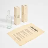 Marcel Broodthaers, Le manuscrit trouvé dans une bouteille (The Manuscript Found in a Bottle) (V. 20), 1974, Multiple comprising Bordeaux transparent glass wine bottle, tissue paper and cardboard box, all with printed text. Accompanied by an additional cardboard box