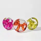 Jeff Koons, Balloon Dog (Magenta); Balloon Dog (Orange); and Balloon Dog (Yellow), 2015, Three porcelain multiples painted in chrome, all contained in the original Styrofoam-lined presentation boxes with printed signature and original plastic stands