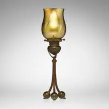 Tripod candlestick with pulled-feather shade by Tiffany Studios, c. 1910, patinated bronze, hand-blown Favrile glass, sold Mar 2026