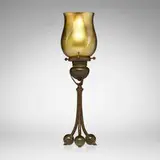 Tripod candlestick with pulled-feather shade by Tiffany Studios, c. 1910, patinated bronze, hand-blown Favrile glass, sold Mar 2026