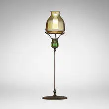 Blown-out candlestick with shade by Tiffany Studios, c. 1910, patinated bronze, hand-blown Favrile glass, hand-blown glass, sold Mar 2026