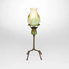 Blown-out candlestick with ribbed pulled-feather shade by Tiffany Studios, c. 1910, patinated bronze, hand-blown Favrile glass, sold Mar 2026