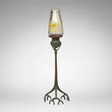 Root candlestick with shade by Tiffany Studios, c. 1910, patinated bronze, hand-blown Favrile glass, sold Mar 2026