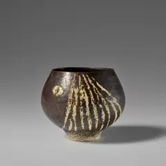 Early pot by Hans Coper, circa 1954, Stoneware, layered manganese glaze and white slip with a carved design beneath a clear glaze, sold Apr 2025