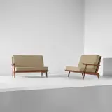 Two single-armed sofas by George Nakashima, 1964, Walnut, fabric, sold Apr 2025