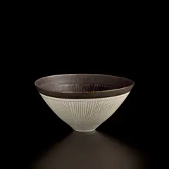 Conical bowl by Lucie Rie, circa 1962, Porcelain, manganese glaze with radiating inlaid and sgraffito design, sold Apr 2025