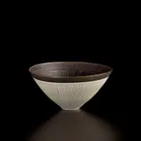 Conical bowl by Lucie Rie, circa 1962, Porcelain, manganese glaze with radiating inlaid and sgraffito design, sold Apr 2025