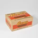 Tom Sachs, Reese's box, 2021, Multiple comprising sealed cardboard box with screenprint in colours on all sides, and Hershey chocolate confectionary contained in plastic wrappers designed by the artist
