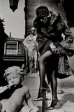 Helmut Newton, Woman in Fur Coat Adjusting Stocking, Paris, 1975, Gelatin silver print, printed early 1990s