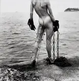 Helmut Newton, Nude in Black Gloves with Metal Leg Support by the Sea, Monte-Carlo, 1994, Gelatin silver print