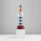 'Agra' totem by Ettore Sottsass, circa 1994, Painted and glazed ceramic, laminated wood, sold May 2024