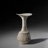 Vase with fluted body and flaring lip by Lucie Rie, circa 1976, Stoneware, pitted glaze with integral speckle, sold May 2024