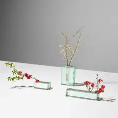 Three flower holders, model nos. 2551, 2393 and 2552 by Fontana Arte, circa 1964, Glass, chrome-plated brass, sold May 2024