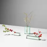 Three flower holders, model nos. 2551, 2393 and 2552 by Fontana Arte, circa 1964, Glass, chrome-plated brass, sold May 2024