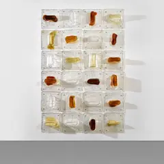 Set of twenty-four modular tiles, from the 'Pannelli' series by Toni Zuccheri, circa 1970, Stracciato a rilievi clear and coloured glass, brass, sold Nov 2024