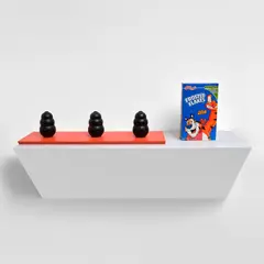 it is III - 2 by Haim Steinbach, 2008, plastic laminated wood shelf, frosted flakes cereal box and three rubber dog chews, sold Mar 2023