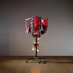 Haegue Yang, Series of vulnerable arrangements, a pair of halves, 2009, clothing rack, casters, metal arms, aluminium Venetian blinds, light bulbs, shoes, rope, metal strainer, metal rings, rubber ring mat, baskets, bells, stainless steel streamer, fly swatters, whistle and plastic funnels​