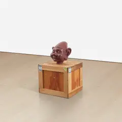 Dwarf Head (chocolate) by Paul McCarthy, 2000, platinum-based silicone and wood crate, sold Dec 2023