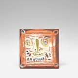 Petit visage barbu (Little Bearded Face) (A.R. 557) by Pablo Picasso, 1968-69, Red earthenware square plaque painted in colours with partial brushed glaze, offered Dec 2023