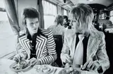 Mick Rock, David Bowie and Mick Ronson, Lunch on Train to Aberdeen, 1973, Archival pigment print, printed later, mounted