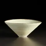 Conical bowl by Lucie Rie, circa 1972, Porcelain, pale green glaze with a feathered manganese rim, sold Apr 2023
