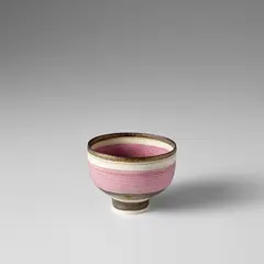 Small footed bowl by Lucie Rie, 1973-1974, Porcelain, pink band over inlaid lines, golden manganese and unglazed bands, sold Nov 2023