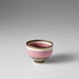Lucie Rie, Small footed bowl, 1973-1974, Porcelain, pink band over inlaid lines, golden manganese and unglazed bands