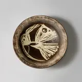 Hans Coper, Large dish, circa 1955, Stoneware, layered manganese glaze and white slip with a carved abstract bird design, beneath a clear glaze