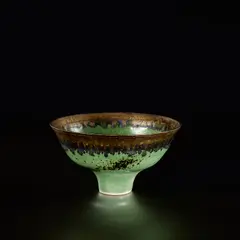 Lucie Rie, Footed bowl, circa 1982, Porcelain, green glaze with golden bronze running rim