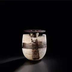 'Sack and Disc' form by Hans Coper, circa 1972, Stoneware, layered porcelain slips and engobes over a textured body with two painted manganese cross designs, the disc a, sold Nov 2023
