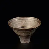 Early bowl by Lucie Rie, circa 1956, Porcelain, manganese glaze with bands of diagonal overlapping sgraffito designs repeated inside and out, sold Nov 2023