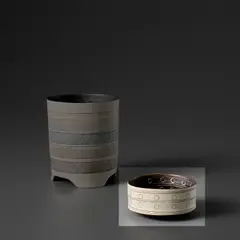 Bowl by Lucie Rie, circa 1958, Porcelain, manganese glaze with sgraffito, impressed and inlaid circles within horizontal bands, sold Nov 2023
