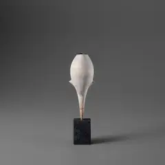 White 'Cycladic Bud' pot by Hans Coper, circa 1975, Stoneware, layered porcelain slips and engobes, the interior with a manganese glaze, the base with a black glaze over a , sold Nov 2023