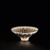 Rare footed bowl by Lucie Rie, circa 1974, Stoneware, inlaid zig-zag design beneath white, manganese and golden manganese glazes, sold Nov 2023