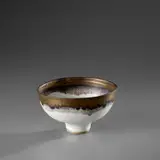Footed bowl by Lucie Rie, circa 1981, Stoneware, matt white glaze, golden lip, sold Nov 2023