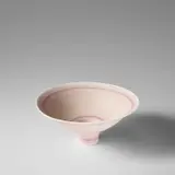 Large footed bowl by Lucie Rie, circa 1982, Porcelain, matt white glaze over a design of parallel pairs of inlaid pink lines repeated inside and out, sold Nov 2023