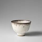 Deep bowl by Lucie Rie, circa 1980, Stoneware, speckled white glaze, feathered manganese rim, sold Nov 2023