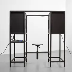Carsten Höller, The Elevator, 2004, 2 TV monitors, 1 laptop, electric cables, adjusting knob and swivel chair in a powder-coated steel sculpture