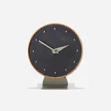 Masonite table clock, model 4767A by George Nelson & Associates, 1949, lacquered wood, Masonite, walnut, enameled steel, enameled aluminum, sold May 2025