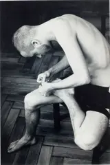 Anders pulling splinter from his foot (b/w) by Wolfgang Tillmans, 2004, Chromogenic print, sold Nov 2022