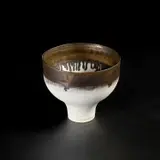 Footed bowl by Lucie Rie, circa 1980, Porcelain, pure matt white glaze with a golden manganese rim, sold May 2022