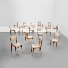Set of sixteen chairs, model no. 671 by Carlo De Carli, circa 1957, Walnut, vinyl, sold May 2022