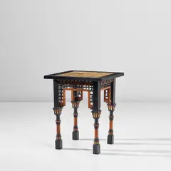 Games table by Carlo Bugatti, circa 1900, Ebonised wood, walnut, bone, vellum with inked illustrations, offered Nov 2022