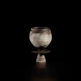 Hans Coper, Cup with central disc, circa 1965, Stoneware, porcelain slips and manganese over a textured body, the interior with a manganese glaze