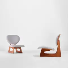 Junzo Sakakura, Two low lounge chairs, model no. 5016, designed 1957, produced circa 1980, Left: Teak-veneered plywood, fabric. Right: Oak-veneered plywood, fabric