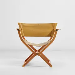 Folding armchair, from the 'Pippa' series by Rena Dumas and Peter Coles, designed 1986, produced circa 1991, Pearwood, leather, brass, sold Nov 2022